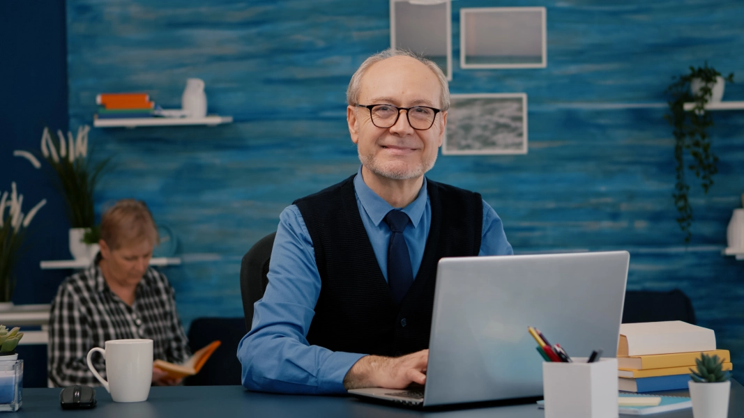 retired-manager-sitting-at-desk-in-front-of-camera-2025-02-20-07-24-54-utc